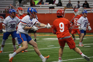 Cornell attack John Piatelli passing near the goal. Syracuse limited the Big Red to three first-half scores on Tuesday. 