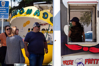 Customers engage in conversation with a vendor in Villa Pizze Fritte’s truck. Villa Pizze Fritte was among 12 different vendors at the event.